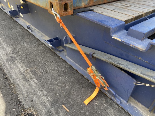 Checking ratchet lashings on a flat rack